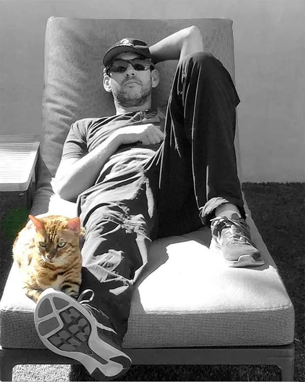 Doug Ellin relaxing outside with his Bengal