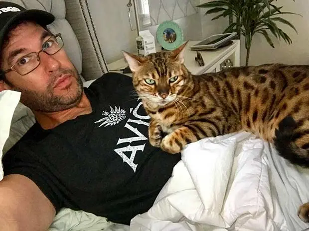 Doug Ellin with his Bengal Tex in bed