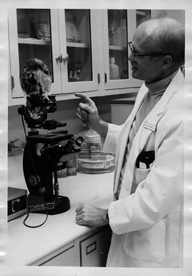 Willard Centerwall in lab with cat at Loma Linda University